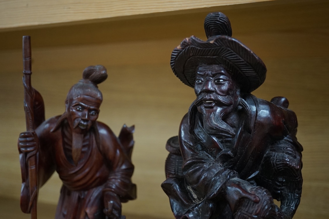 Three Chinese carved wood figures of elders, largest 37cm high